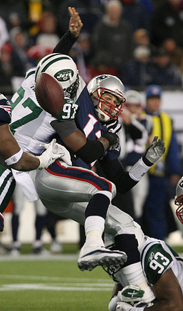 Calvin Pace of the NY Jets sacks Tom Brady of the New England Patriots, causing a fumble in the AFC Divisional Game.  Foxboro, Massachusetts