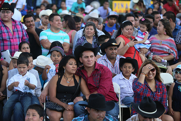 The crowd watches the rodeo entertainment that included games with a rodeo clowns as he played with members of the audience.