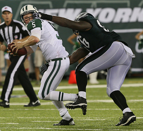 NY Jets quarterback Matt Simms has his face mask pulled by Bennie Logan of the Philadelphia Eagles.  East Rutherford, NJ