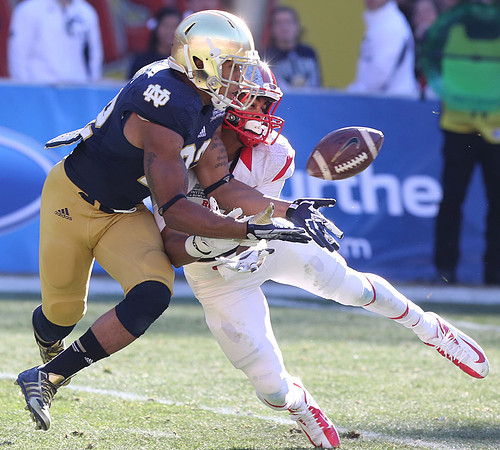 Elijah Shumate of Notre Dame breaks up a pass meant for Brandon Coleman of Rutgers during the Pinstripe Bowl. Bronx, NY