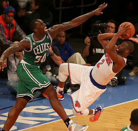 Brandon Bass of the Celtics defends against Raymond Felton during the NBA Playoffs.  Manhattan, NY