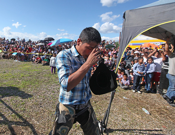 This bull rider, Chonta blesses himself after his ride.