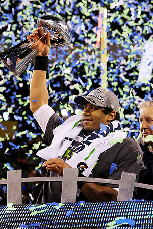 Seattle Seahawks quarterback Russel Wilson holds up the Lombardi Trophy after his team won Super Bowl XLVIII. East Rutherford, NJ