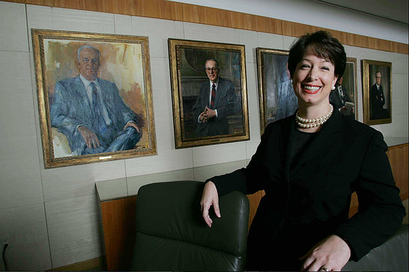 Carrie Cox, Executive Vice President of Pharmaceuticals at Schering Plough in a conference room with portraits of past male executives. Kenilworth, NJ