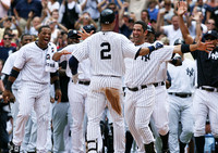 Derek Jeter is greeted at home plate after a hitting a home run to register his 3000th hit. Bronx, NY
